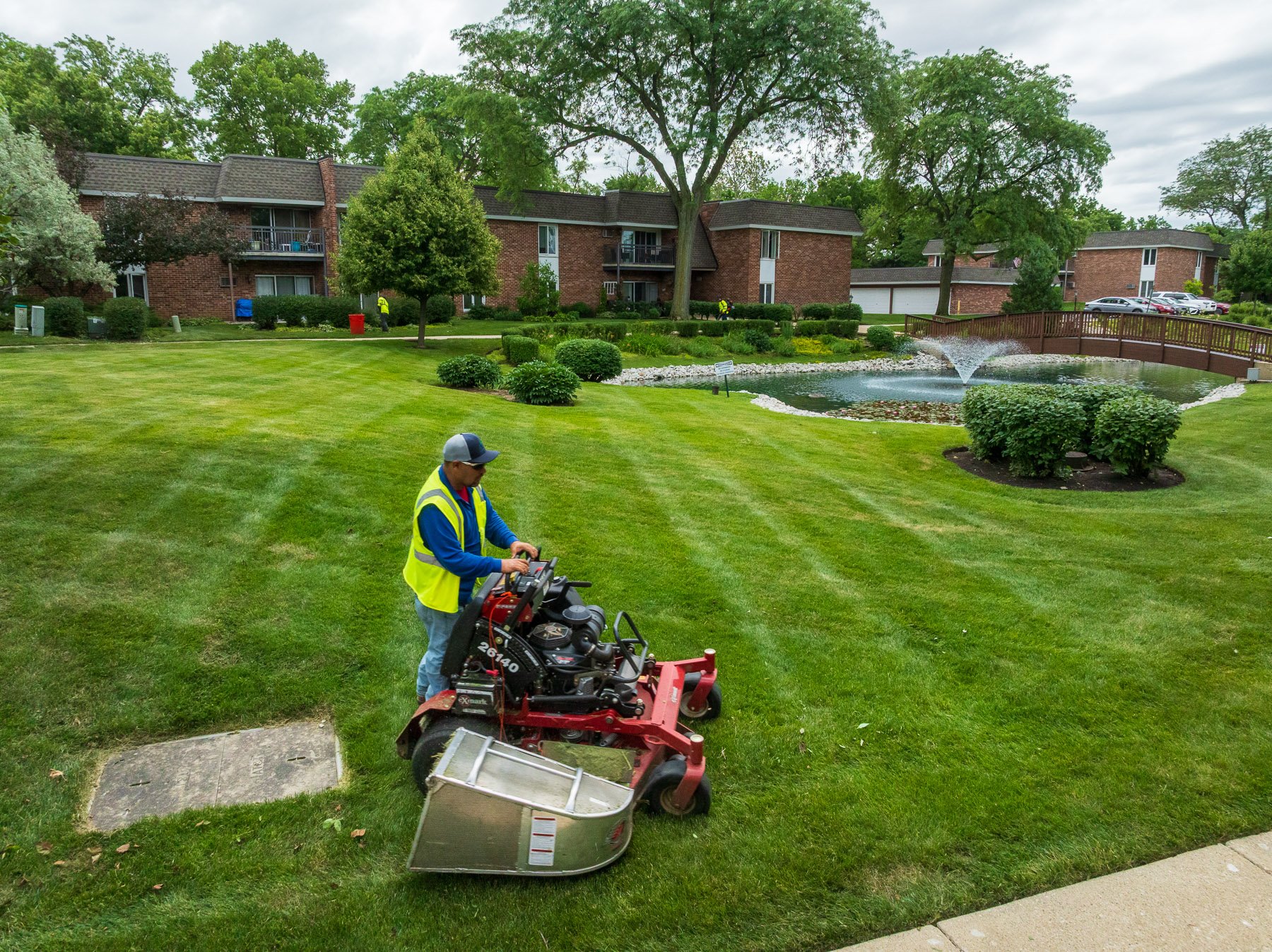 Professional crew mowing a lush green residential lawn